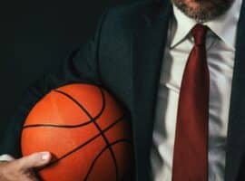 business professional holding a basketball representing NBA corporate careers.