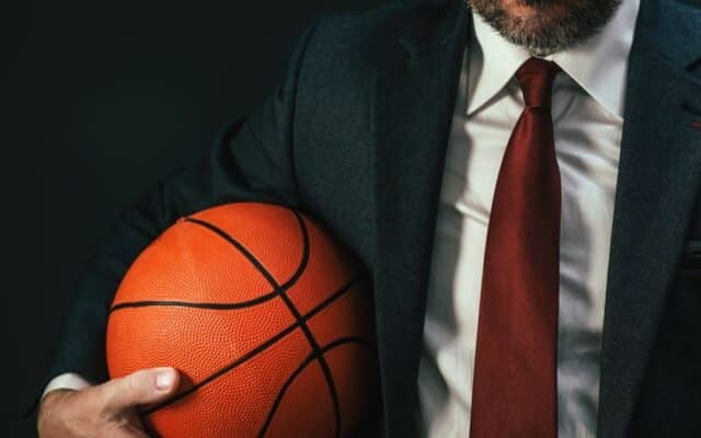 business professional holding a basketball representing NBA corporate careers.