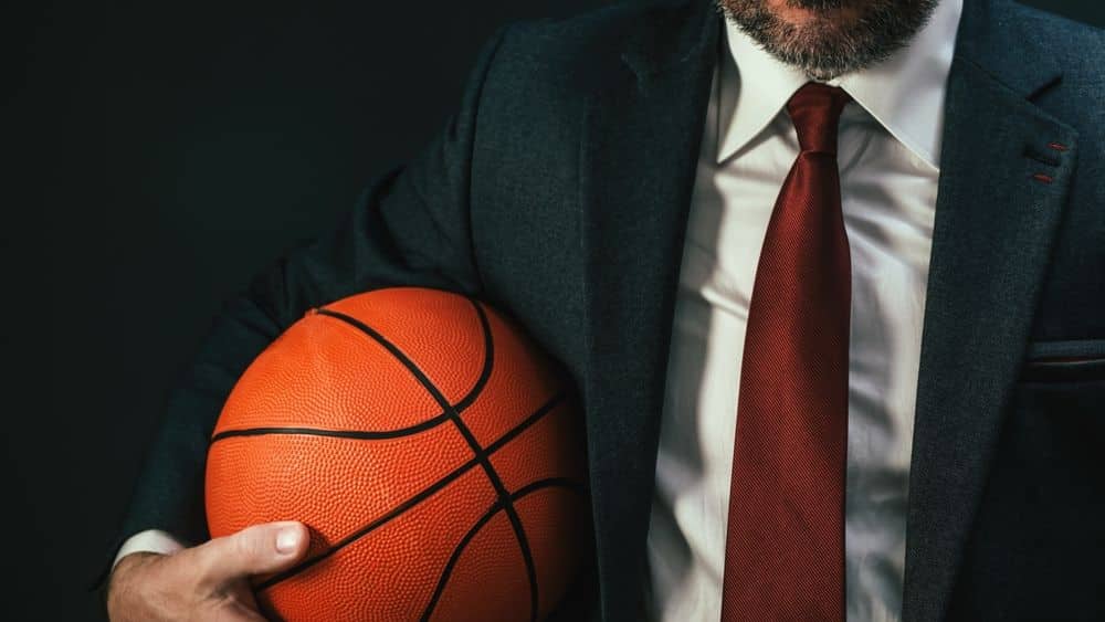 business professional holding a basketball representing NBA corporate careers.