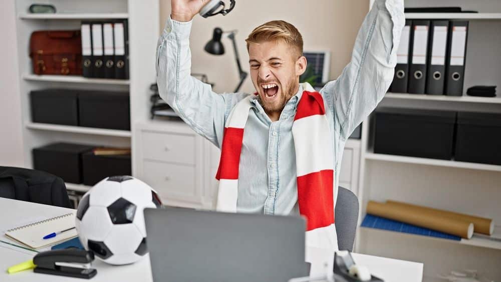 Excited Soccer Fan Working From Office.
