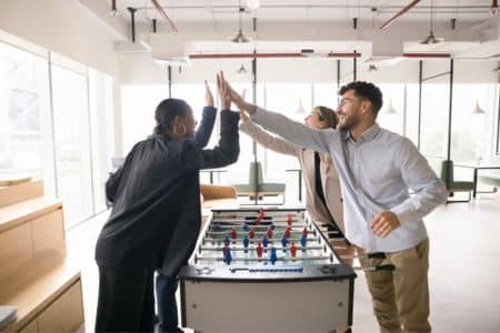 Coworkers Celebrating Win at the Foosball Table