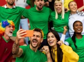 sports fans creating content and celebrating team community at game